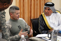 Army Col. Butch Kievenaar, commander of the 4th Infantry Division’s 2nd Brigade Combat Team, talks with a sheik from Iraq’s Basra province about civil action projects in a June 16 meeting at the Basra Operations Center.