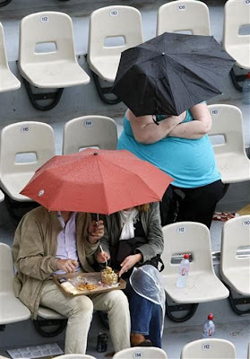 fat-lady-with-small-umbrella-football-stadium