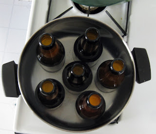Heating bottles of sake in a water bath to pasteurize