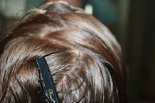 Top view of girl's hair being styled into "Zig-Zag Part"