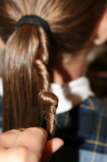 Young girl's hair being styled in to "Ponytail Of Twists" hairstyle