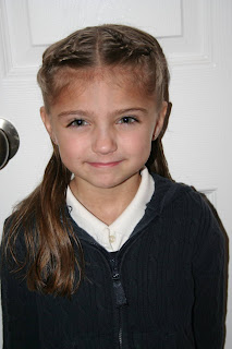 Portrait of a young girl modeling “French Designer Heart” hairstyle