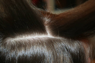Close up view of young girl having her hair styled as "teen heart" hairstyle 2