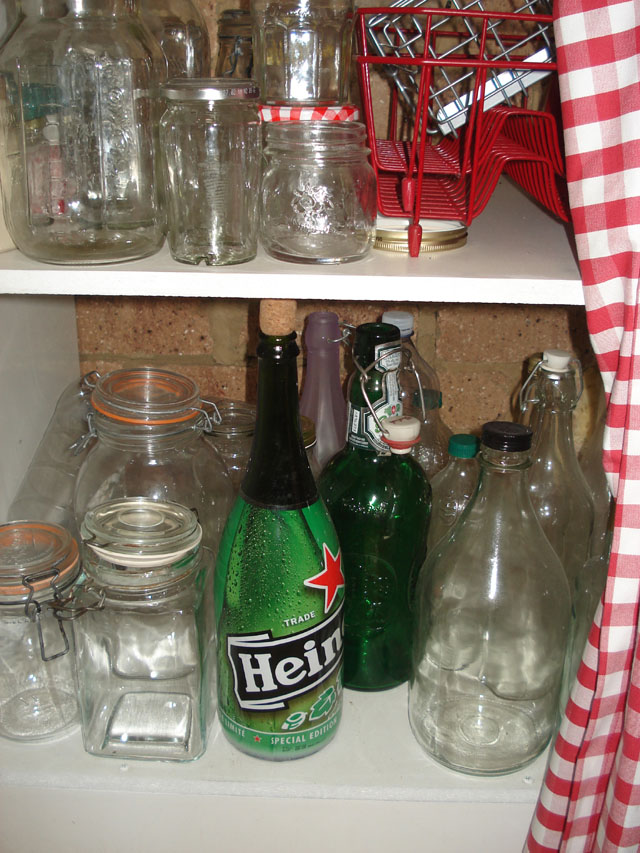 Two green bottles for recycling down to earth