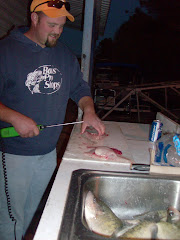 Eric, the Bumpus Mills Fisherman, cleaning his 9 crappies with an electric filleting knife