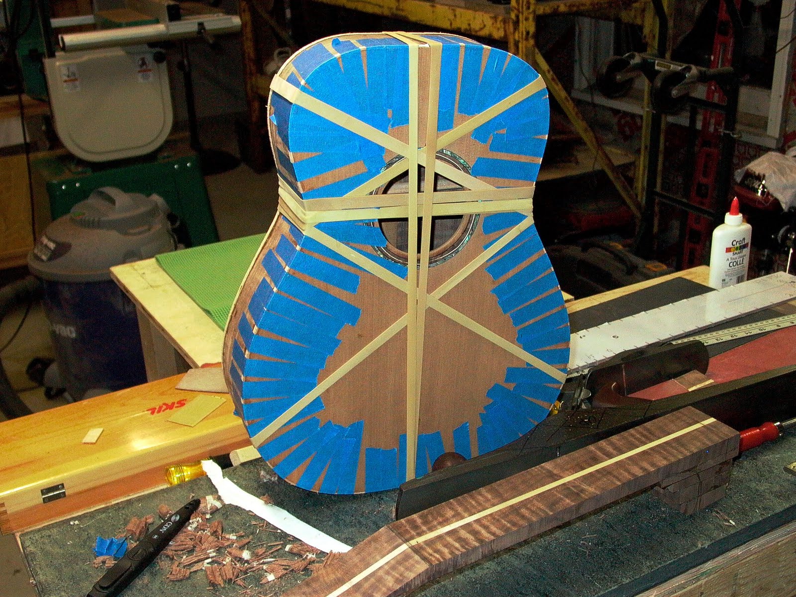 ThreeQuartersLeft Applying the binding on a walnut and cedar acoustic