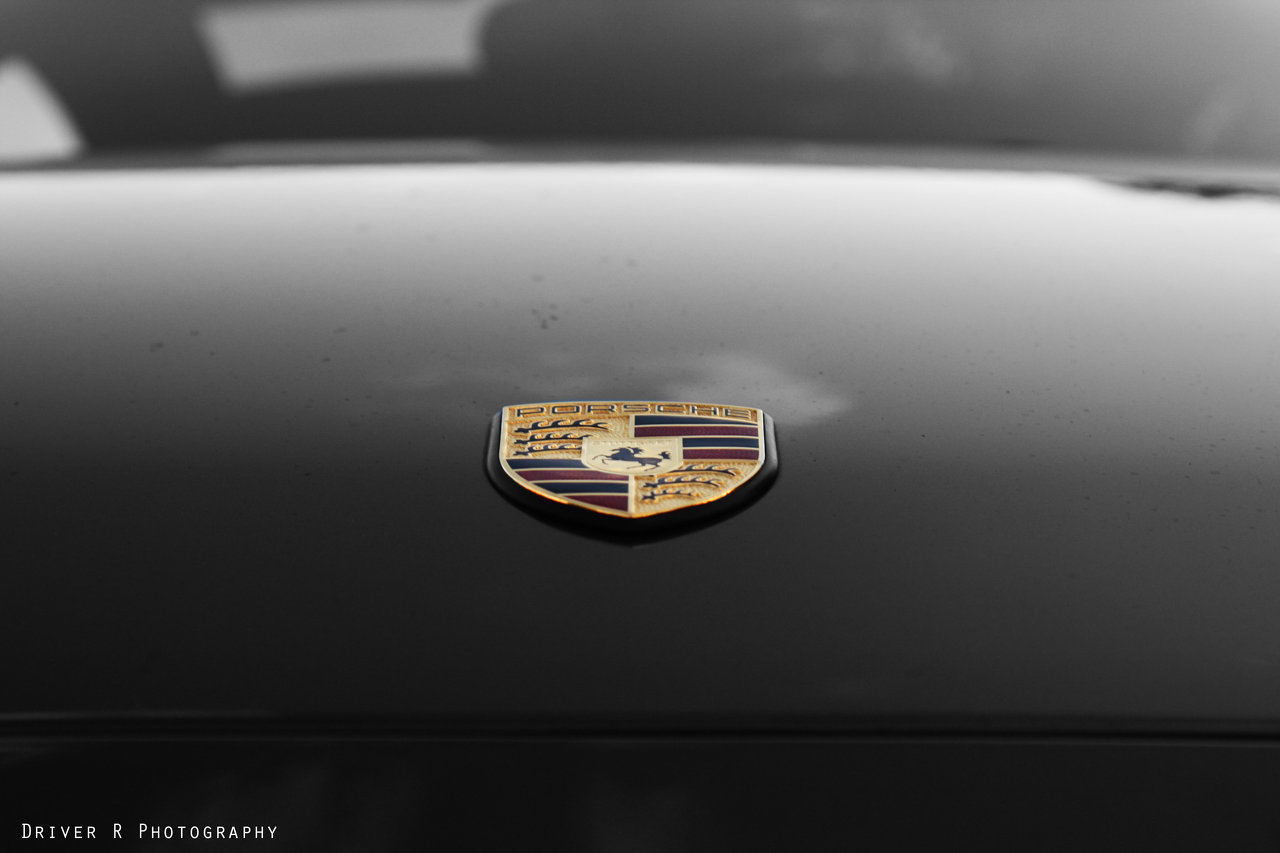 Porsche logo on black car