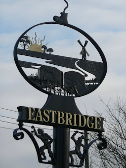 On the left is Eastbridge Village sign. On the right a view looking towards the Minsmere Toll Bridge, locally known as the Tu Penny bridge