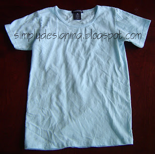Plain Blue t-shirt with scoop neck on a table