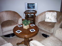 seating area in kitchen with tabletop screen and Tigers coasters on table