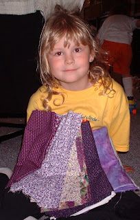Abby at 8 with purple fabrics for her first quilt