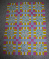 pink, yellow, blue and white charity quilt