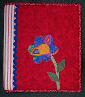 notebook cover made from fabric with an appliqued flower on the front received from the Pay It Forward I signed up for at Linda's blog