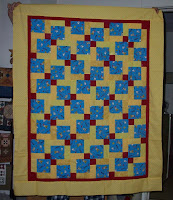 Disappearing Nine Patch top using Snoopy fabrics, red centers and four different yellows