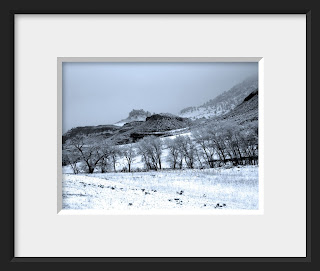 A framed photo of a cold winter's day in the canyon brings snow and fog to the foothills of Colorado.