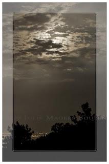 A framed sepia print of the full moon rising over the silhouette of the Rocky Mountains in Colorado.