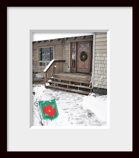 A framed photo of my very own front door and snowy stone walk decorated for the holidays beckon the weary traveler to stop in for a cup of hot chocolate.