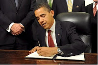 President Obama signs a bill 