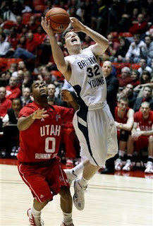 BYU's Jimmer Fredette drives in the lane against a University of Utah player