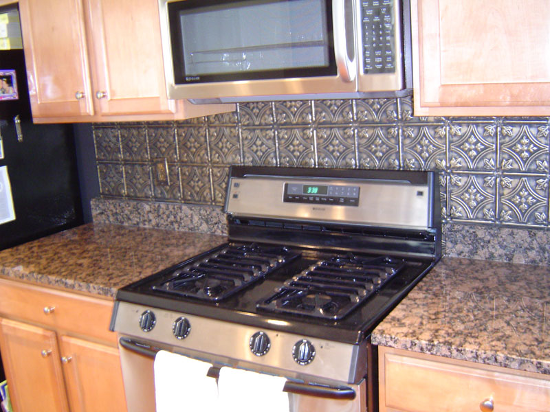 The faux tin backsplash is an easy and relatively inexpensive kitchen