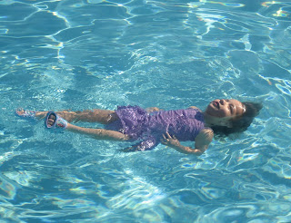 Little girl learning to float on her back