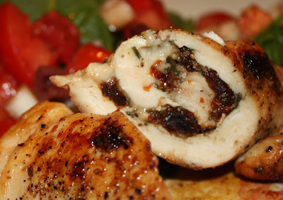 close up of piece of chicken rolled with pesto and sun dried tomatoes