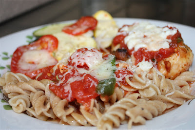 plate of pasta with vegetables and chicken parmesan