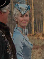 Young Marie Antoinette makes a funny face while talking to king Louis XV, a film still from the 2006 film Marie Antoinette