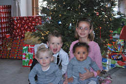 The kids in their Christmas outfits right the Sunday before Christmas.