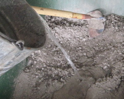 Hand mixing concrete in a wheelbarrow