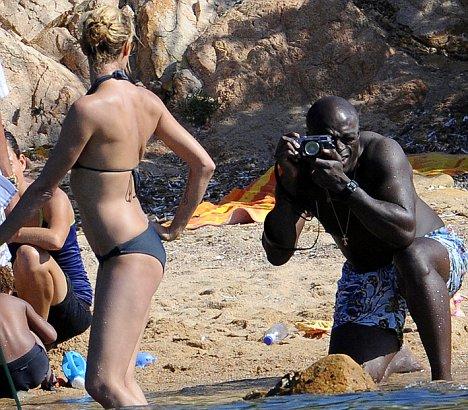 Heidi Klum strikes a bikini pose on the beach