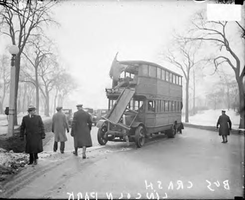 Police officers looking at double-decker bus accident. Chicago 1930
