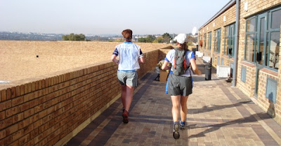 Lauren and Debbie follow the green signs leading us off the roof and back on to Wessels Road