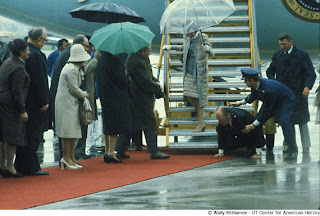 President Ford slips and falls as he leaves Air Force One upon arrival in Vienna, Austria for a state visit.