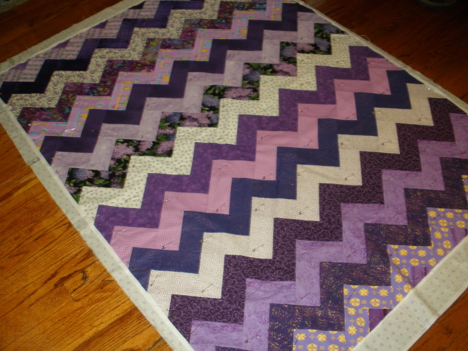 Phosphorelated Fibers quilting the purple zigzag quilt!
