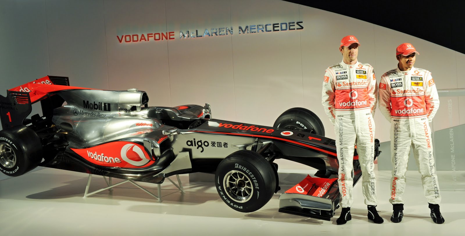 [Jenson+Button+(L)+and+Lewis+Hamilton+pose+for+photographs+beside+the+McLaren+Mercedes+MP4-25+Formula+1+racing+car.jpg]