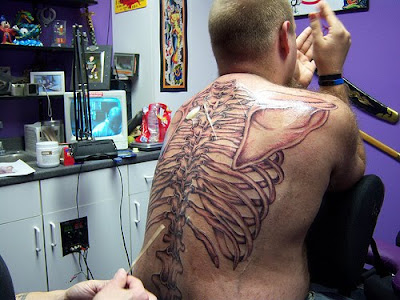 tattoos for men on back shoulder.  distracts from tattoos 