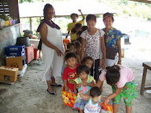 STUDENTS LINE UP IN THE OUTDOOR SCHOOL FOR GOODIES