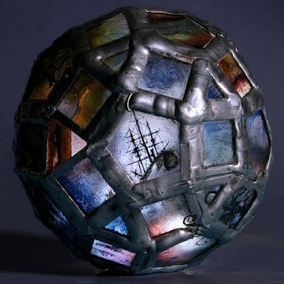 The 'Storm Troubled Sphere' a 75mm diameter bead made from 60 pieces of glass, hand painted with kiln fired enamel.
