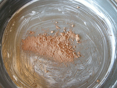 Sprinkle tablespoon of cocoa powder in greased pan.