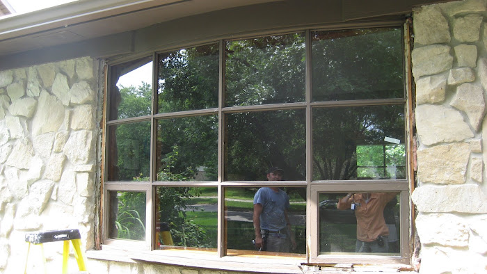 "Before" exterior of an older single-pane bow window