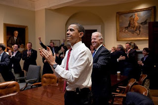 Obama applauding health care vote in oval office with others