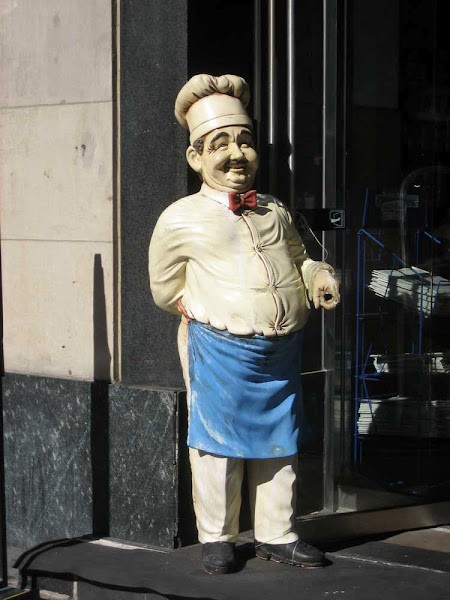 Rude Chef - A sidewalk chef (on 5th Ave. near 30th St.) makes a gesture with his left hand that's bound to be an insult somewhere.