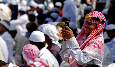 eid04 Muslim boy clicks photos of the people with his mobile after Eid al Fitr Prayers in Hydrabad, India