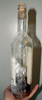 Wrapping half a bottle of wine in fondant as a mold to shape a sugar bottle