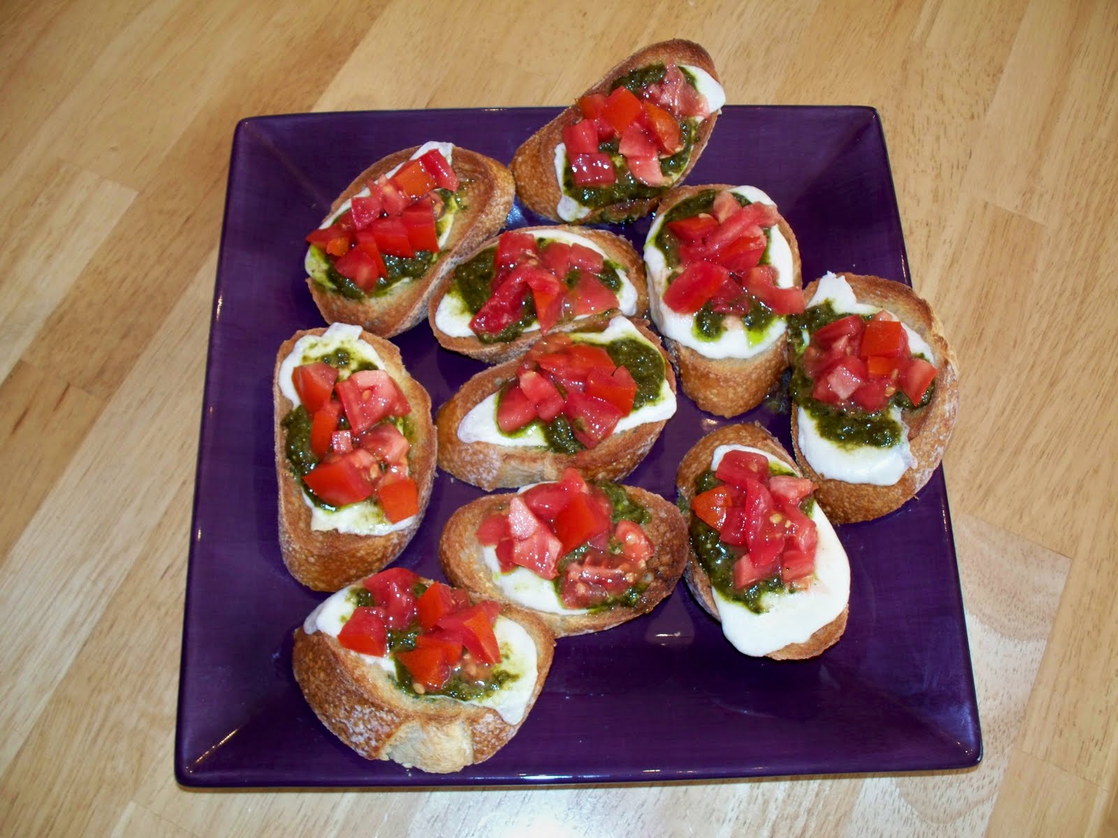 The Purple Cook Mozzarella, Pesto, and Tomato Bruschetta