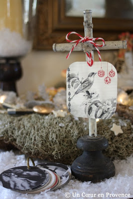 A litte cross in a Christmas decoration with lichen