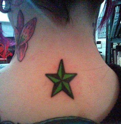 Green nautical star tattoo and red flowers on young girls' neck.