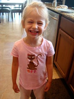 Little girl standing in the kitchen smiling