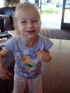 Young girl standing with mouth full of food